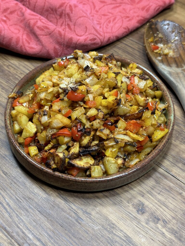 air fryer breakfast potatoes with onions and peppers on a plate