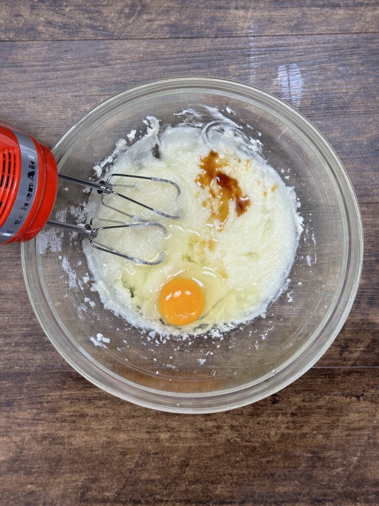 Sugar and butter mixed together with the wet ingredients egg and vanilla extract